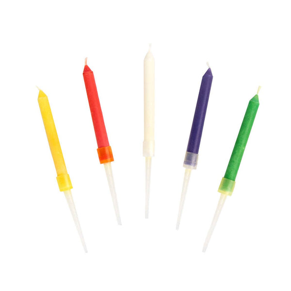 Set of colorful candles with rainbow wicks on a white background
