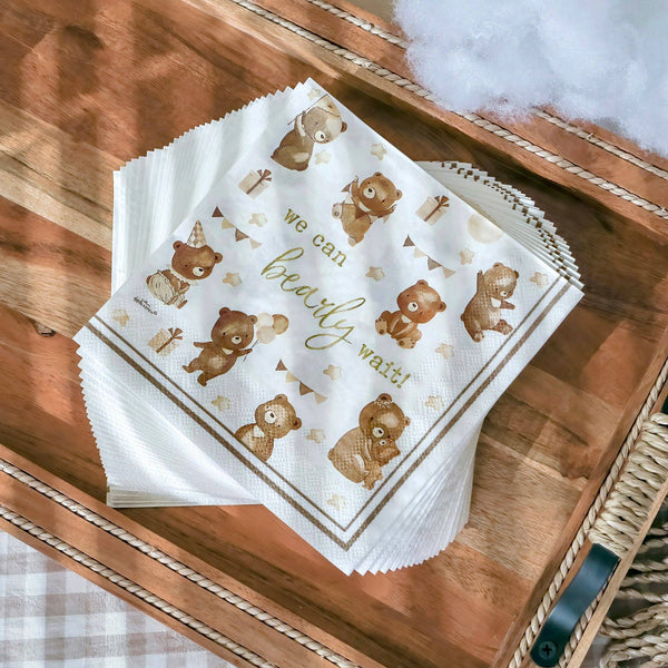 Stack of paper napkins with teddy bear design on a wooden surface