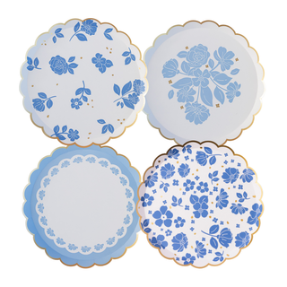 Set of four decorative plates with blue floral patterns on a white background