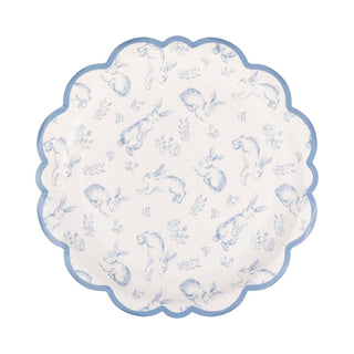 Round scalloped edge paper plate with blue animal pattern on a white background