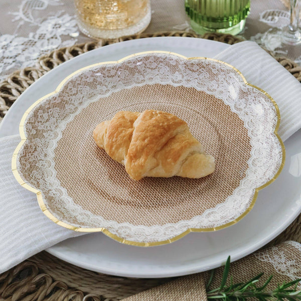 Croissant on a decorative plate with lace edge and burlap center