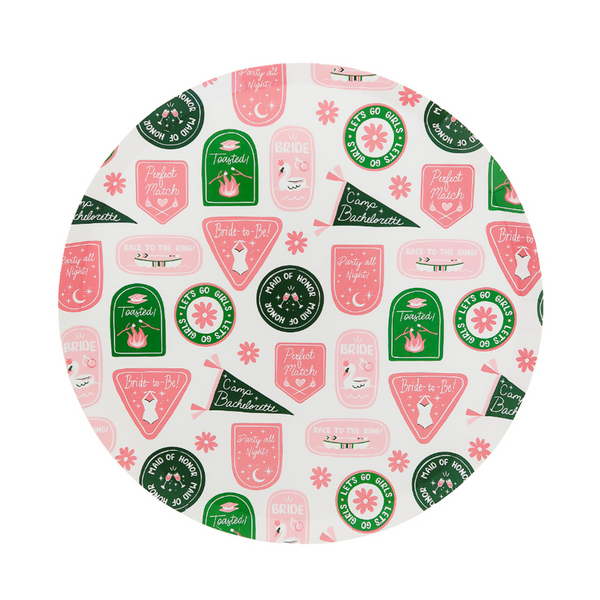 Circular paper plate with pink and green designs on a white background