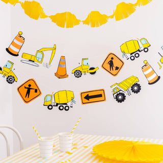Construction-themed wall decals on a white wall with yellow decorations.