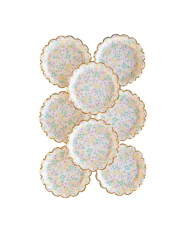Set of floral paper plates with gold edges on a white background