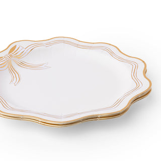White plate with gold decorative edge on a white background