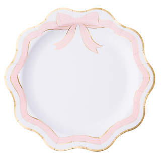 Decorative plate with pink bow and scalloped edge on a white background