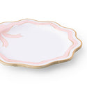 Set of white plates with pink rims and gold edges on a white background