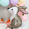 Gold foil balloon shaped like a bunny with balloons and carrots in the background