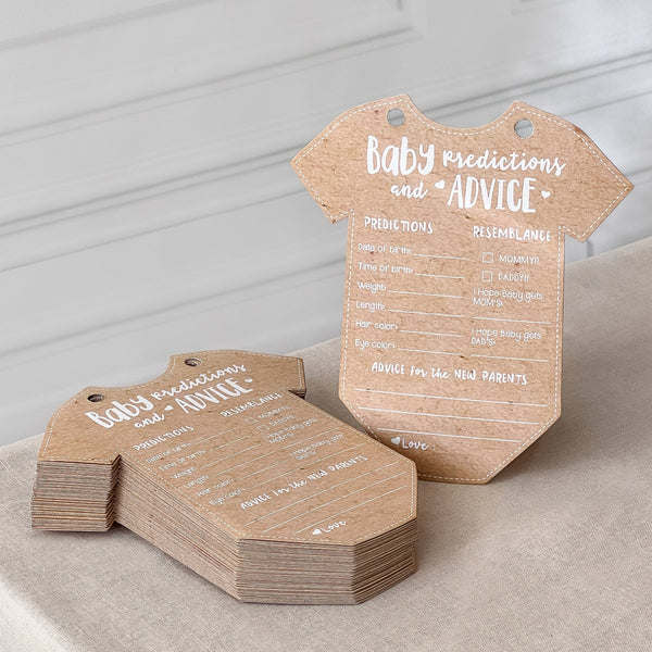 Kraft paper baby onesie-shaped cards with text on a neutral background