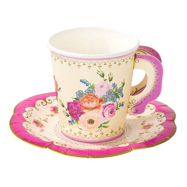 Decorative paper cup with floral design on a matching saucer against a white background