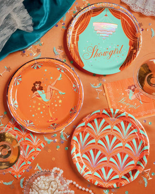 Decorative plates with artistic showgirl designs on a colorful background