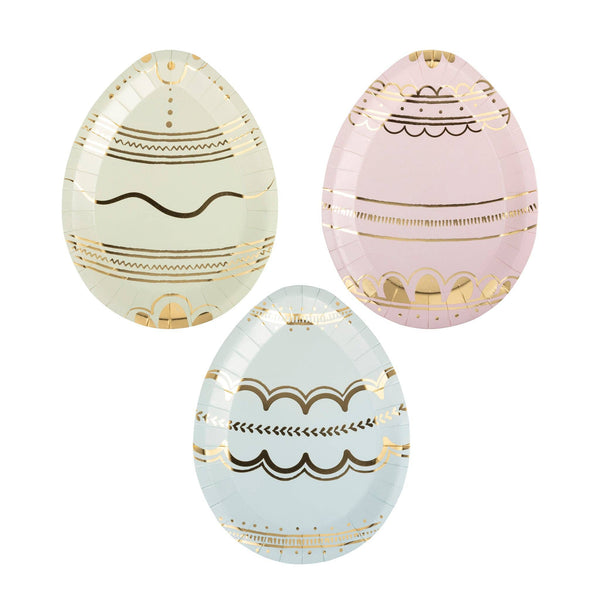 Three decorative eggs with gold and black patterns on a white background