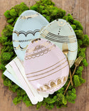 Decorative Easter egg plates with gold patterns on a green moss background