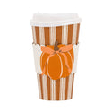 A paper coffee cup sleeve with a white lid, featuring a brown and white striped design and an orange pumpkin graphic with a bow.