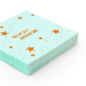 Stack of turquoise napkins with orange stars and text on a white background