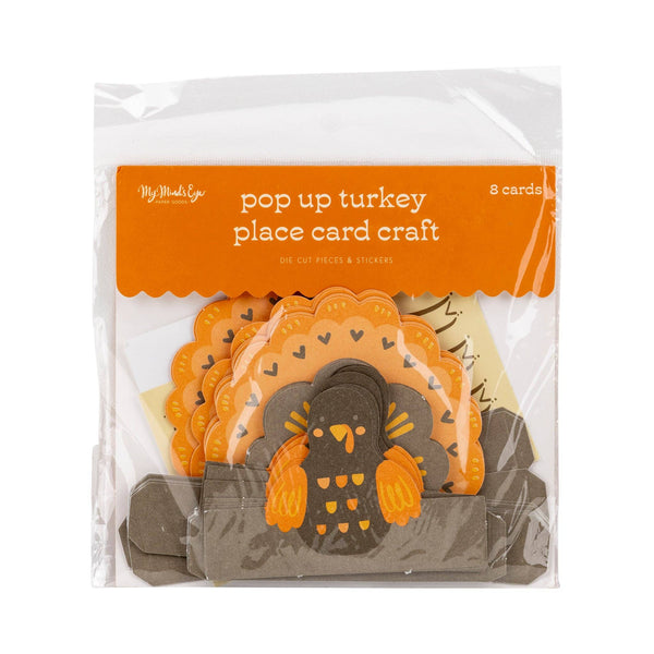 Pop-up turkey place card craft in packaging with orange label Turkey Thanksgiving Table Place Cards | Oh So Fancy Party