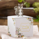 Card with a squirrel topper and floral design on a soft surface