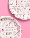 Patterned paper with book-themed illustrations on a pink background