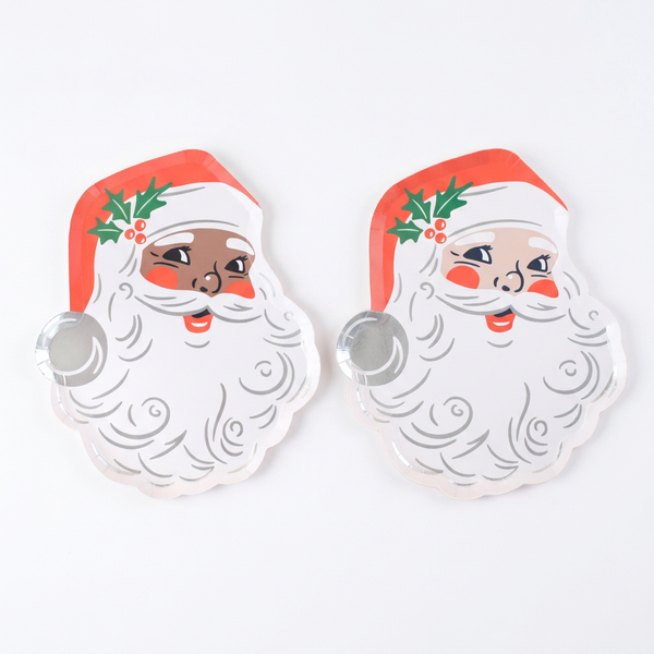 Black Santa and White Santa vintage St. Nick paper plates lying flat side by side