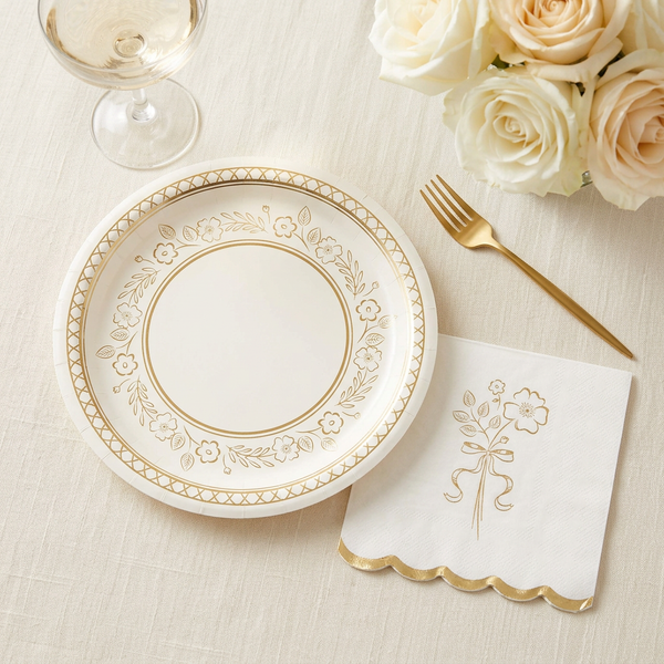 Coordinating gold foil floral napkin and gold-and-cream plate styled together