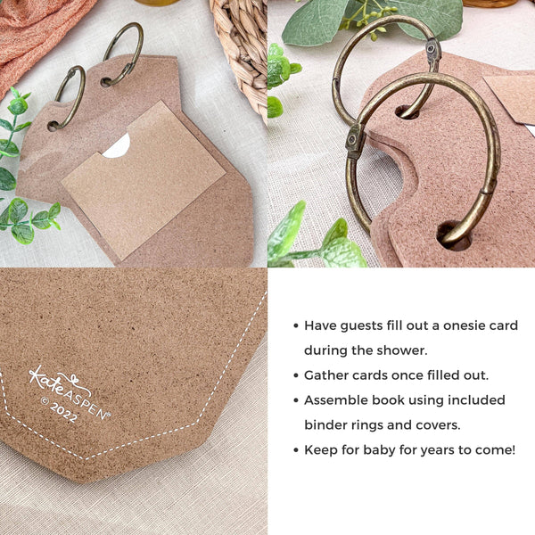 Cork-bound baby book with binder rings and a onesie card holder on a textured surface with greenery.