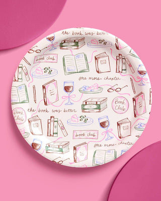 Round plate with book-themed design on a pink background