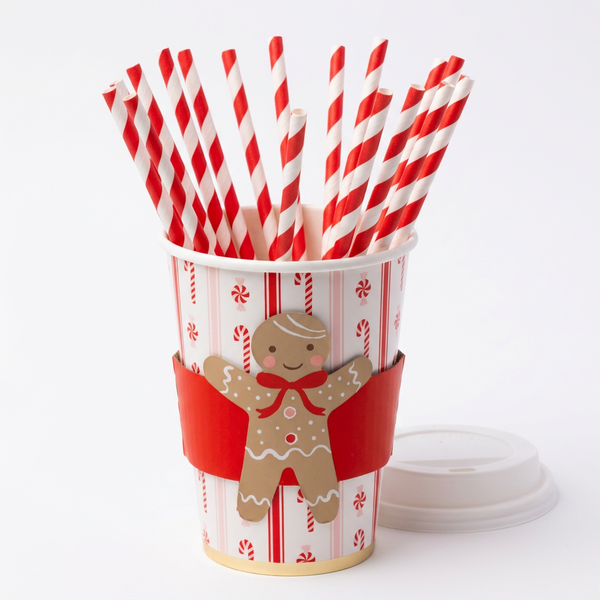 Gingerbread cup with its lid beside it and 20 red-and-white striped straws loosely arranged inside