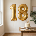 Gold 18 balloons in a styled birthday setting