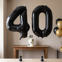 Black number 4 and 0 foil balloons styled together for a 40th birthday celebration