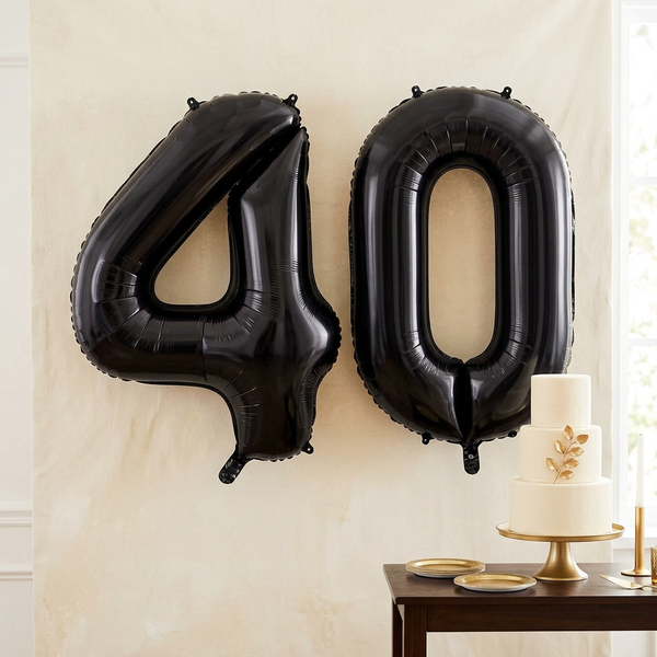 Black 40 number balloon bundle styled against an ivory backdrop for a 40th birthday party