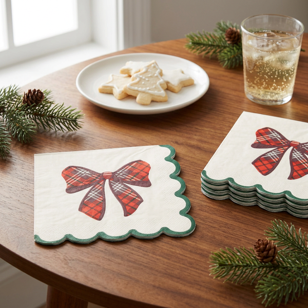 Plaid bow Christmas napkins styled on a cozy cookie table