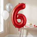 Red number 6 foil balloon in a sixth birthday party setting
