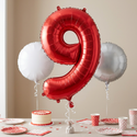 Red number 9 foil balloon in a ninth birthday party setting