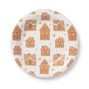 Round gingerbread house plate on a white background