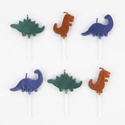 Six dinosaur candles lying flat on a white background, two of each design