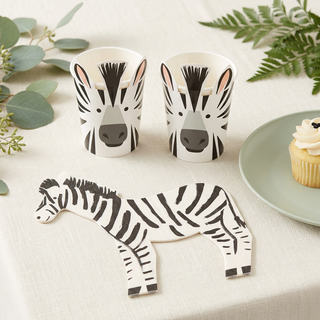Zebra napkin and matching zebra cups styled on a safari party table